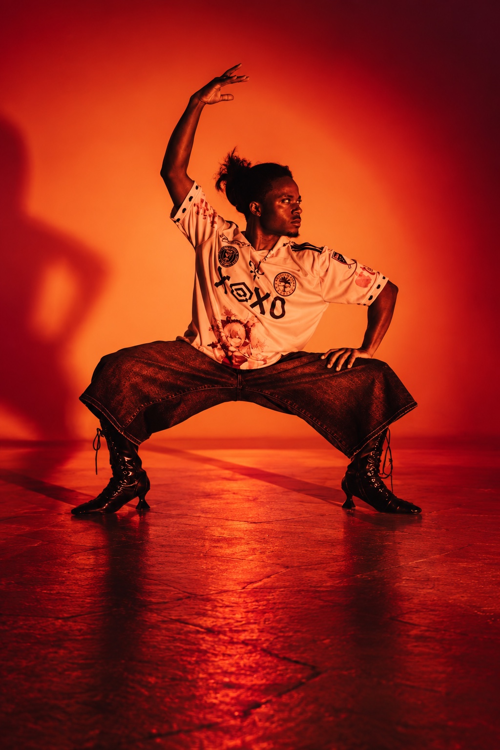 TERRANCE DEAN in a dance pose under amber light