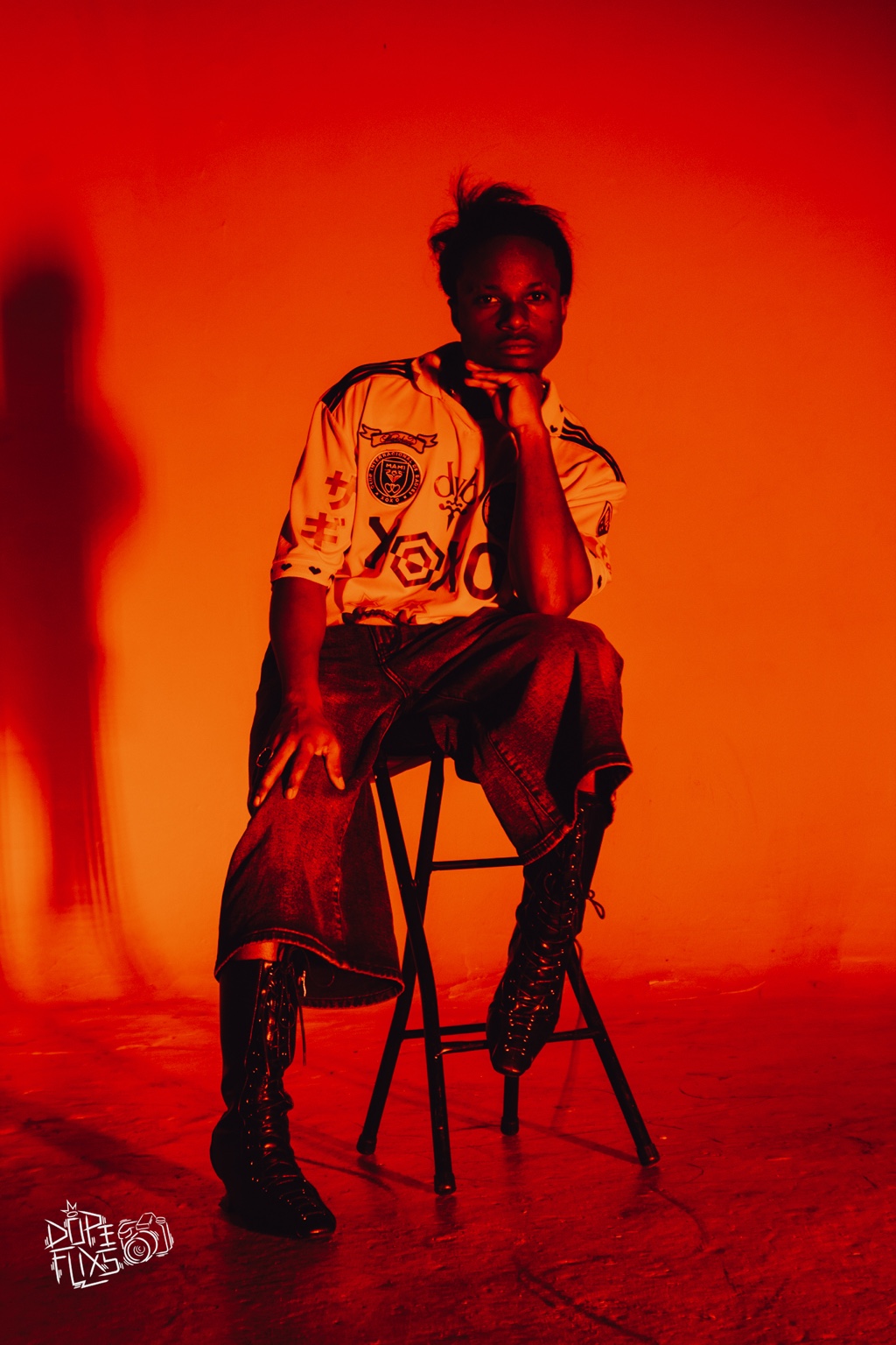 TERRANCE DEAN seated on a stool in amber light