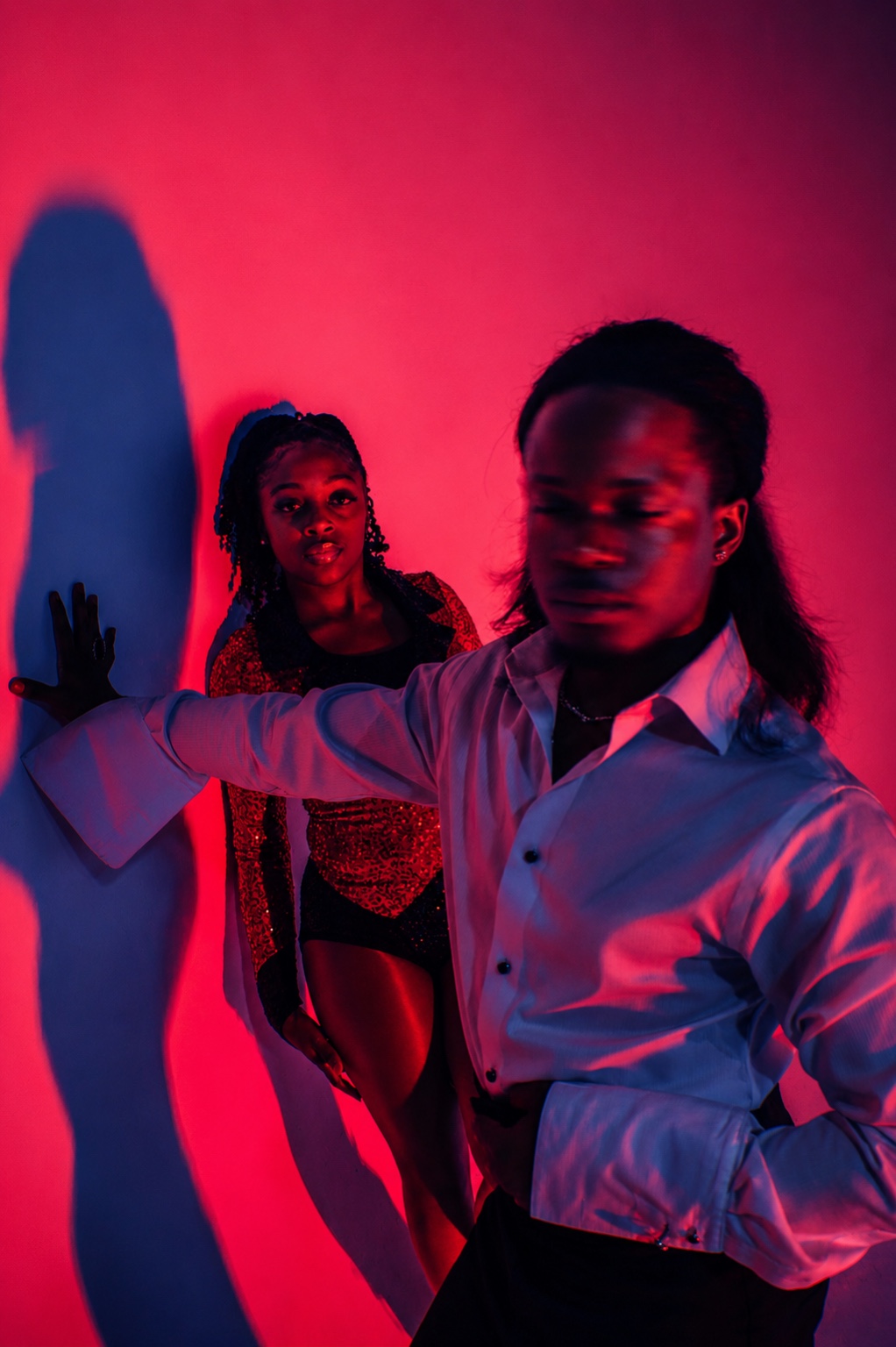 TERRANCE DEAN and a dancer beneath red and violet studio lighting